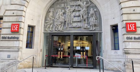 Front entrance of Old Building with stone carved mural at the London School of Economics