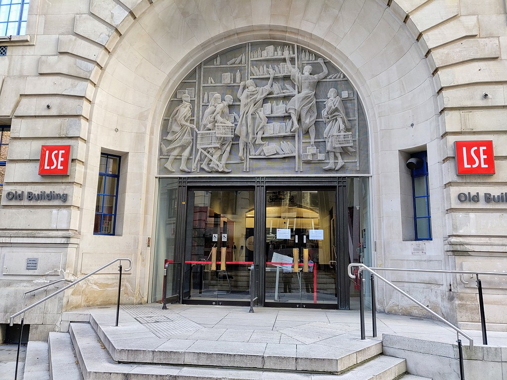 Front entrance of Old Building with stone carved mural at the London School of Economics